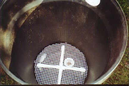 Plastic grate at the bottom of a barrel
