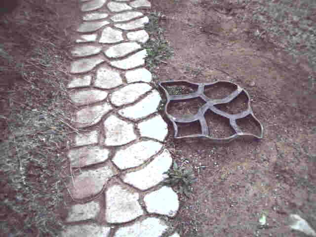 Pouring with the form, next to finished blocks
